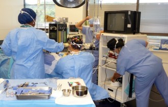 Dr. Ricardo L. Rodriguez, in the operating room, performing cosmetic surgery.