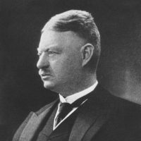 A black and white side profile photo of Gustav Neuber