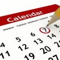 A pen marking a date on a calendar.