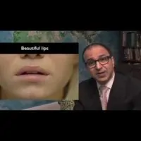 Dr. Ricardo L. Rodriguez sitting behind his desk in front of a world map.