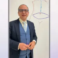 Dr. Rodriguez standing in front of a dry erase board illustrating the Lockwood technique for tummy tucks