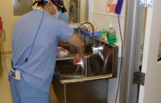 Dr. Ricardo L. Rodriguez scrubbing his hands according to AAAASF guidelines for scrub protocols