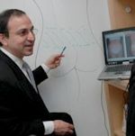 Dr. Ricardo L. Rodriguez standing in front of a whiteboard.