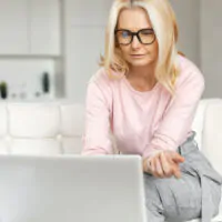 Middle-aged woman having a virtual consultation from home on her laptop