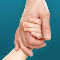 A child's hand holding an adult's hand.